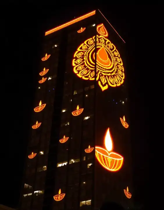 Skyscraper illuminated with Diwali diyas and rangoli patterns at night | Illuminated Diwali Skyscraper | Diwali Light Show | Decorations Guru