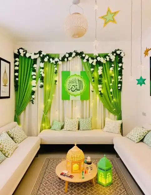 Green Eid Mubarak backdrop with floral garland, lanterns, and star decorations | Eid Mubarak Green Curtain Backdrop with Floral and Lantern Accents | Eid al-Adha Festive Decoration Ideas | Decorations Guru