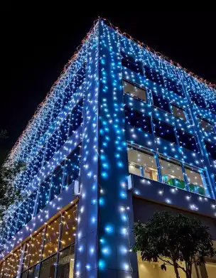 Diwali building decoration with blue and white string lights at night | Diwali Outdoor Lighting Display for Buildings | Festival Decorations - Outdoor | Decorations Guru