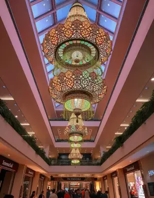 Grand chandeliers illuminating a mall for Diwali celebration with intricate colorful designs | Stunning Diwali Mall Decoration with Grand Chandeliers | Indoor Festival Decor Ideas | Decorations Guru