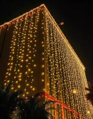 Diwali light curtain illuminating a building facade with warm lights | Elegant Diwali Light Curtain for Building Exterior | Low Budget Simple Outdoor Decor | Decorations Guru