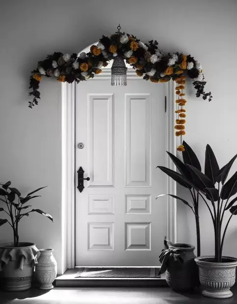 Floral garland and marigold-adorned Diwali door decoration with greenery and hanging lantern | Elegant Floral Diwali Door Decoration with Marigold and Greenery | Outdoor Festival Decorations | Decorations Guru